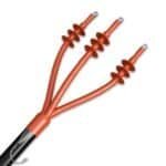 High voltage electrical cable with orange coil insulators, used in power transmission for renewable energy projects, solar power, and energy infrastructure.